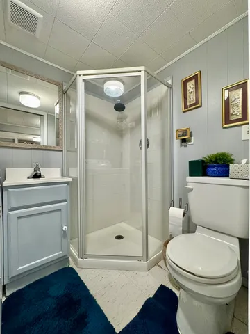 a bathroom with a toilet a sink and shower