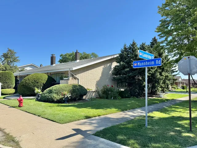 a view of a table and chairs under an umbrella