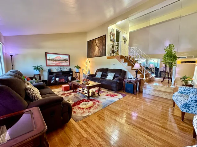 a living room with furniture kitchen view and a table
