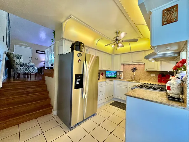 a kitchen with refrigerator and cabinets