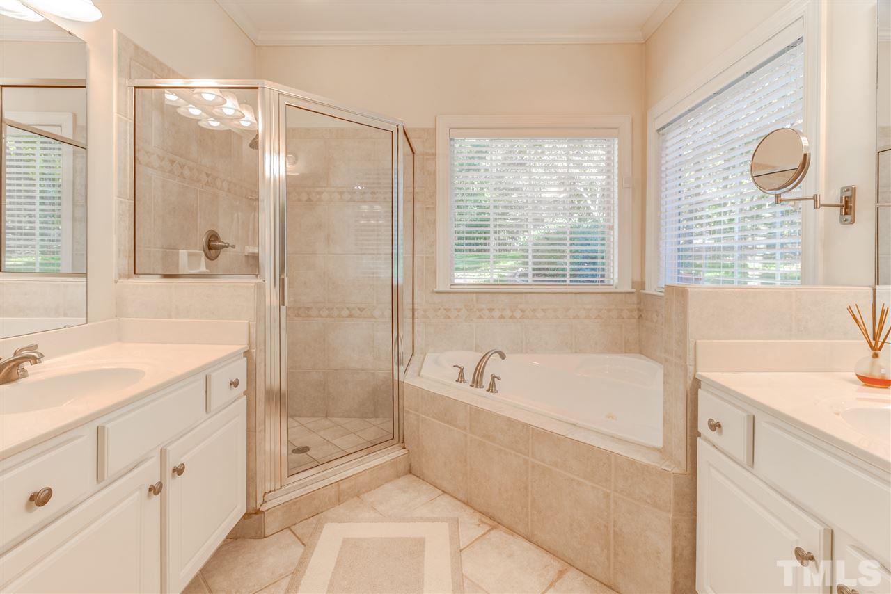 11604 John Allen Road Raleigh, NC 27614 - Photo 15 of 25 a spacious bathroom with a granite countertop tub sink a mirror a shower and a bathtub