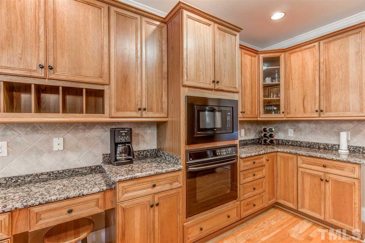 11604 John Allen Road Raleigh, NC 27614 - Photo 6 of 25 a kitchen with granite countertop a sink stainless steel appliances wooden cabinets and a counter space