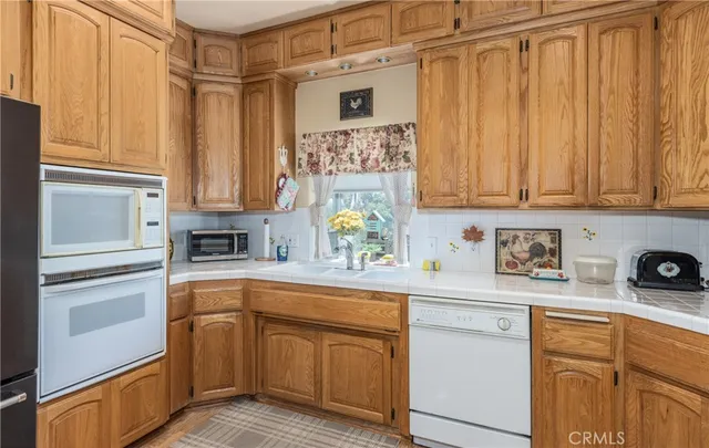 a kitchen with a table chairs stove and cabinets