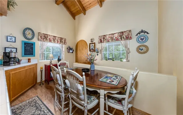a dining room with furniture and wooden floor