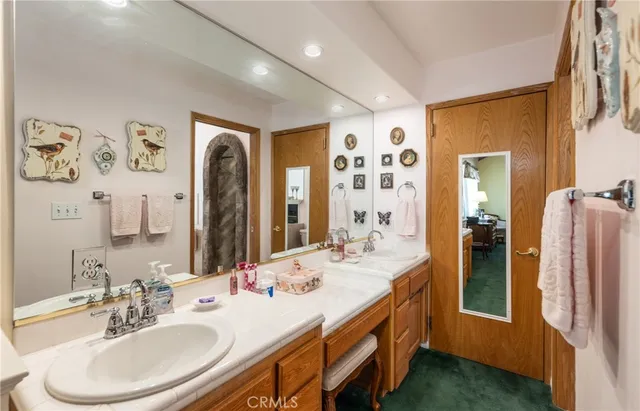 a bathroom with a sink a large mirror and a bathtub