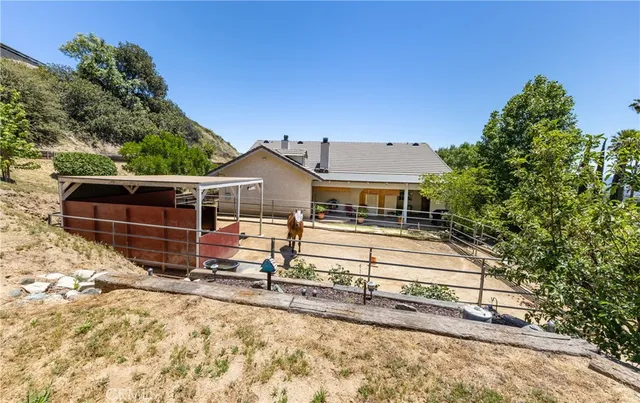 an aerial view of a house with a yard and potted plants