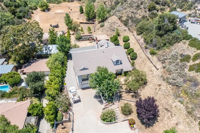 an aerial view of a house with a yard