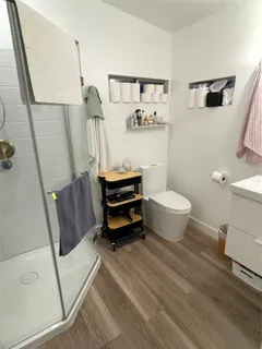 a bathroom with a sink a toilet and a mirror