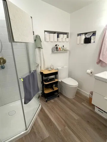 a bathroom with a sink a toilet and a mirror