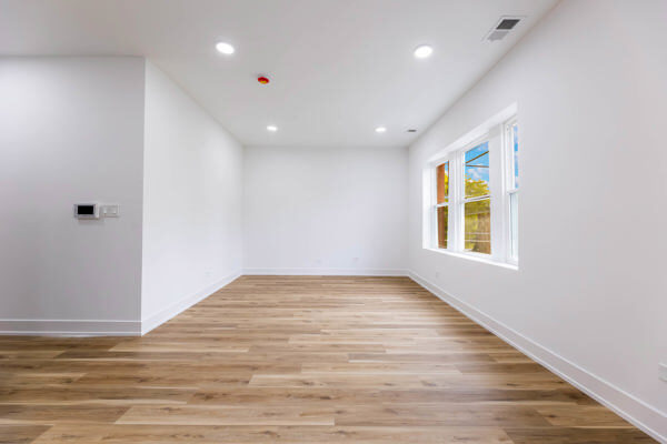 243 West 74th Street, Unit 2 Chicago, IL 60621 - Photo 7 of 12 a view of empty room with wooden floor and fan