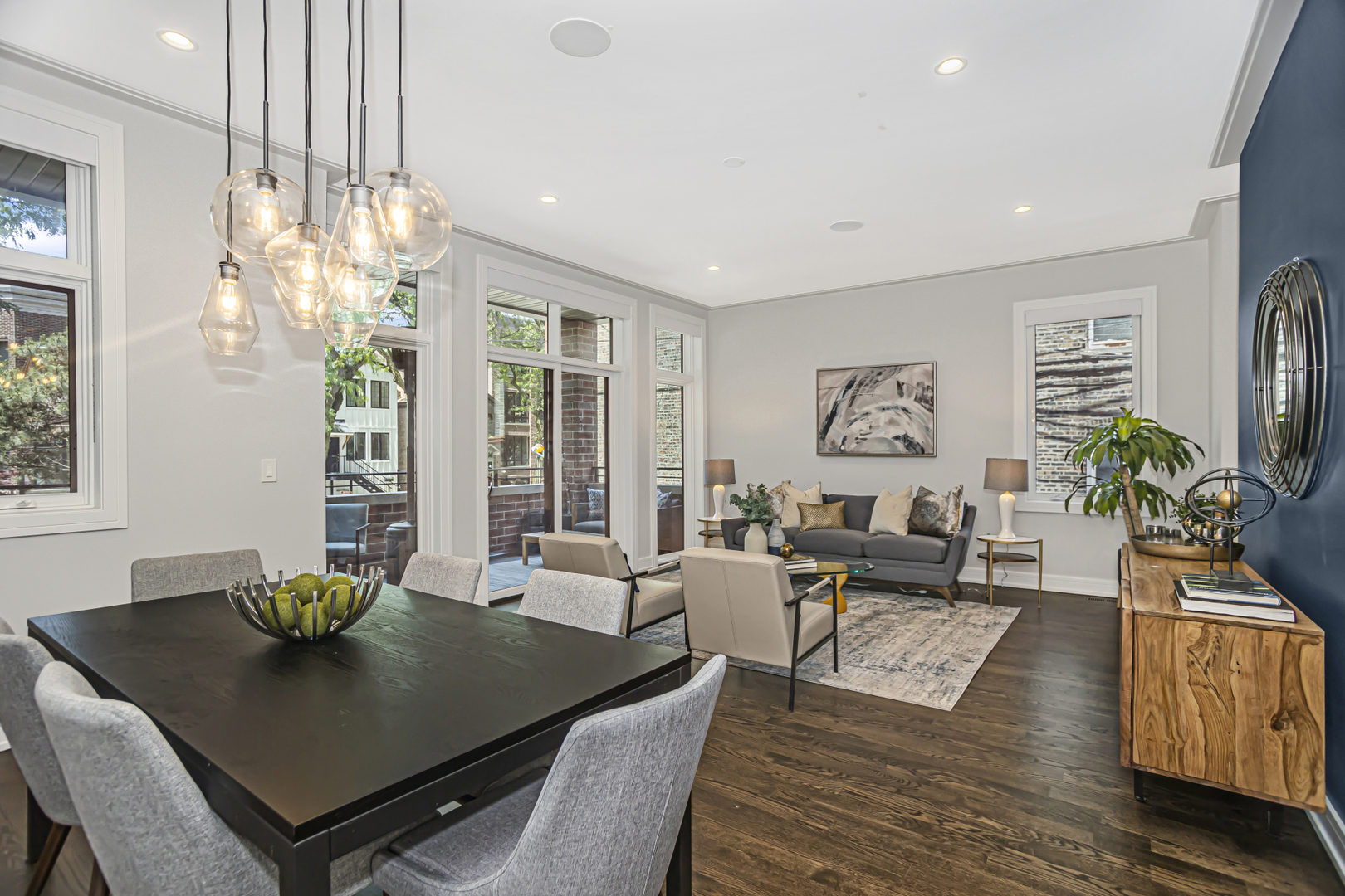 715 South May Street, Unit 1N Chicago, IL 60607 - Photo 5 of 25 a living room with furniture a chandelier a large window and potted plant