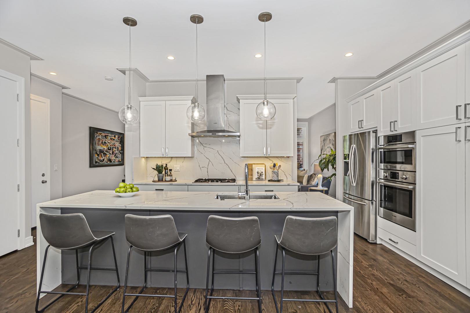 715 South May Street, Unit 1N Chicago, IL 60607 - Photo 7 of 25 a kitchen with stainless steel appliances kitchen island granite countertop a table chairs and a refrigerator