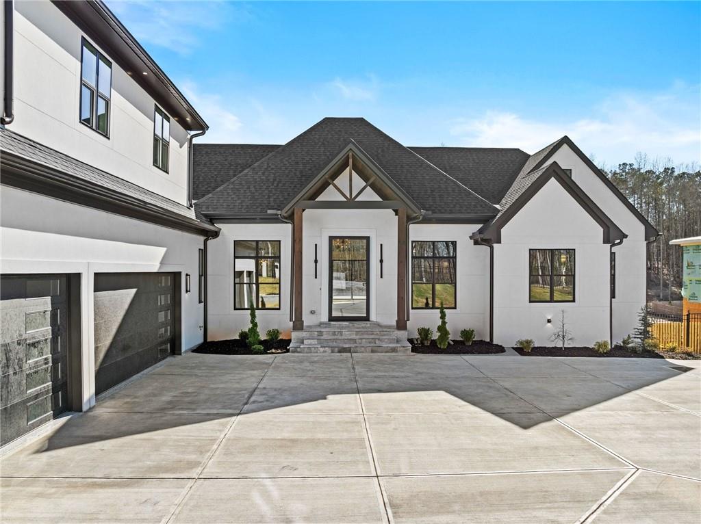 6996 Deaton Henry Road Hoschton, GA 30548 - Photo 2 of 65 a front view of a house with a yard