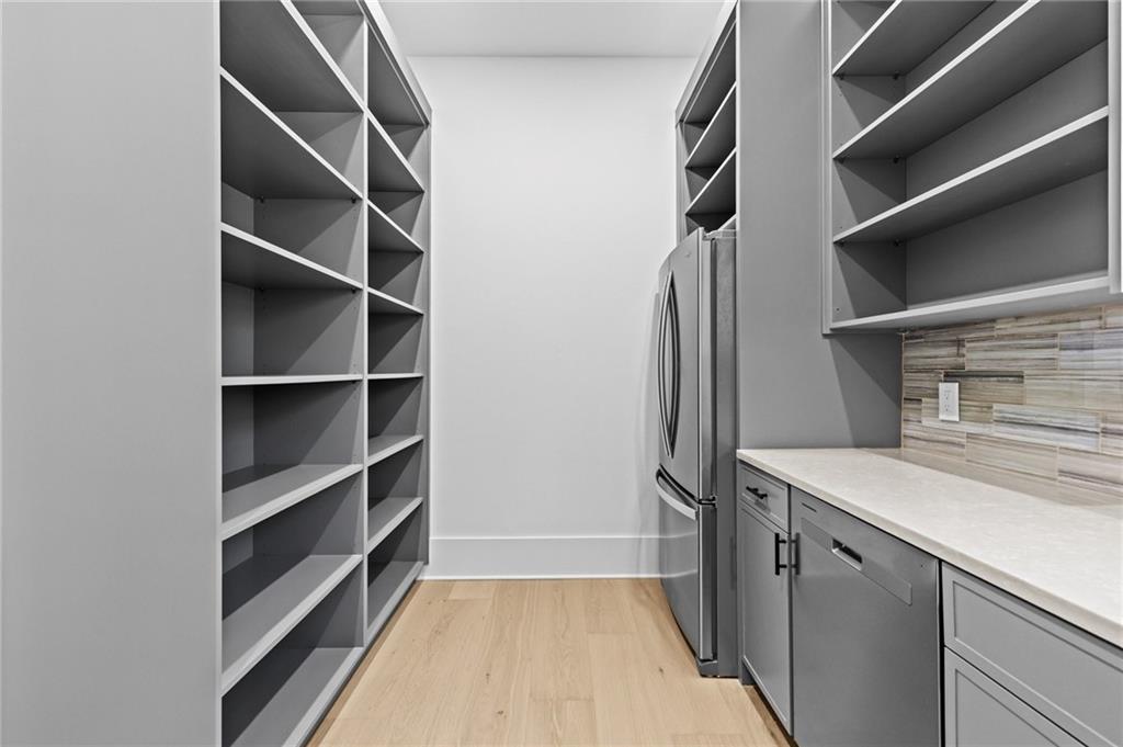 6996 Deaton Henry Road Hoschton, GA 30548 - Photo 21 of 65 a view of walk in closet with empty racks