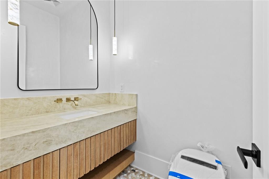 6996 Deaton Henry Road Hoschton, GA 30548 - Photo 22 of 65 a bathroom with a sink and a mirror