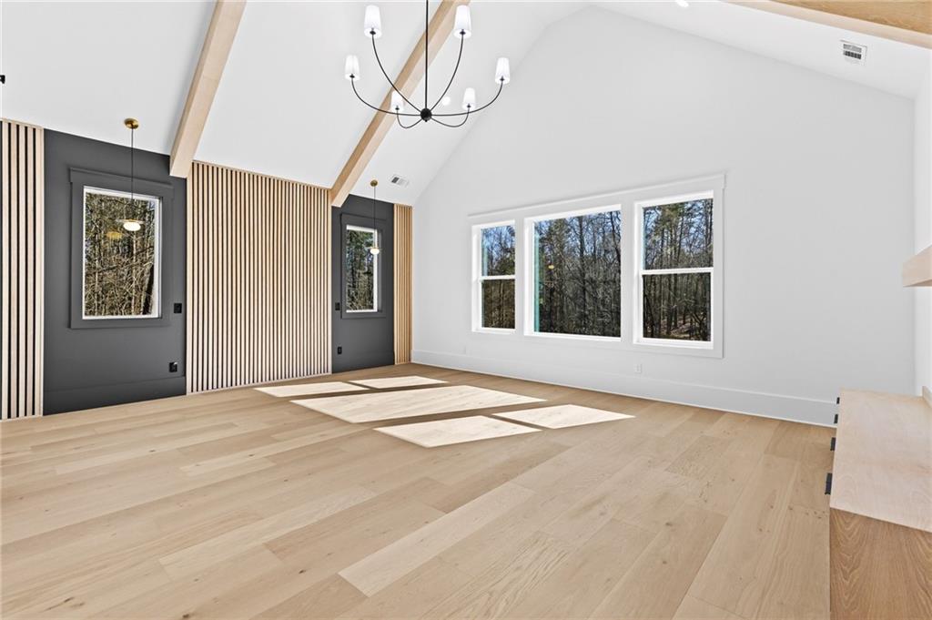 6996 Deaton Henry Road Hoschton, GA 30548 - Photo 23 of 65 a bedroom with a large bed and a window