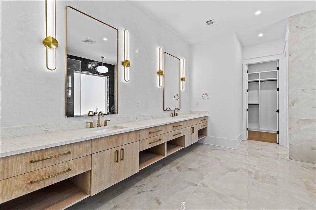 6996 Deaton Henry Road Hoschton, GA 30548 - Photo 25 of 65 a spacious bathroom with double vanity sinks and a mirror