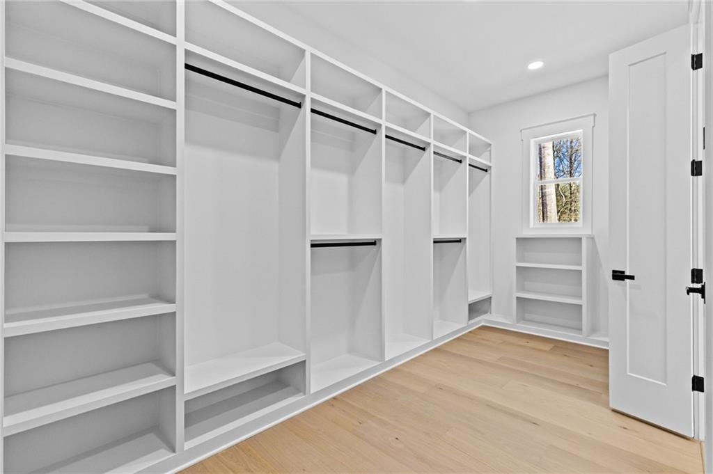 6996 Deaton Henry Road Hoschton, GA 30548 - Photo 28 of 65 a view of walk in closet with empty racks