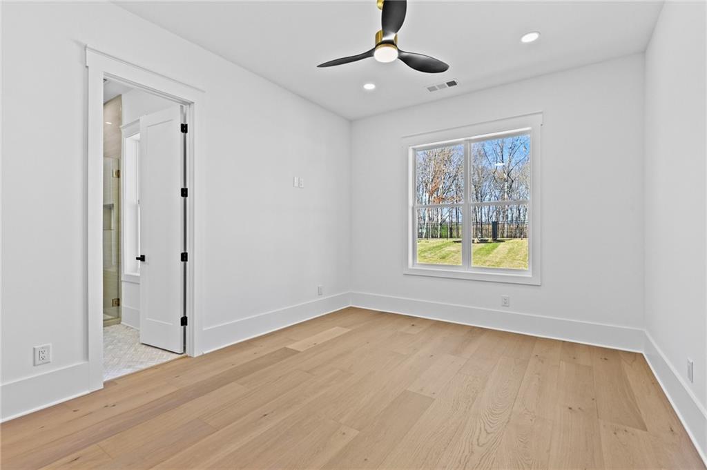 6996 Deaton Henry Road Hoschton, GA 30548 - Photo 36 of 65 a view of an empty room with window and wooden floor