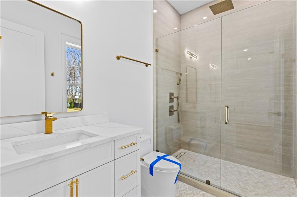 6996 Deaton Henry Road Hoschton, GA 30548 - Photo 37 of 65 a bathroom with a sink and a mirror