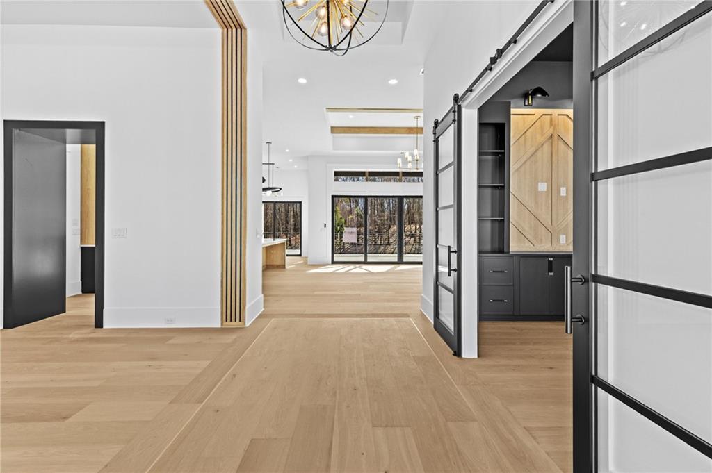 6996 Deaton Henry Road Hoschton, GA 30548 - Photo 4 of 65 a view of a hallway with wooden floor and entryway