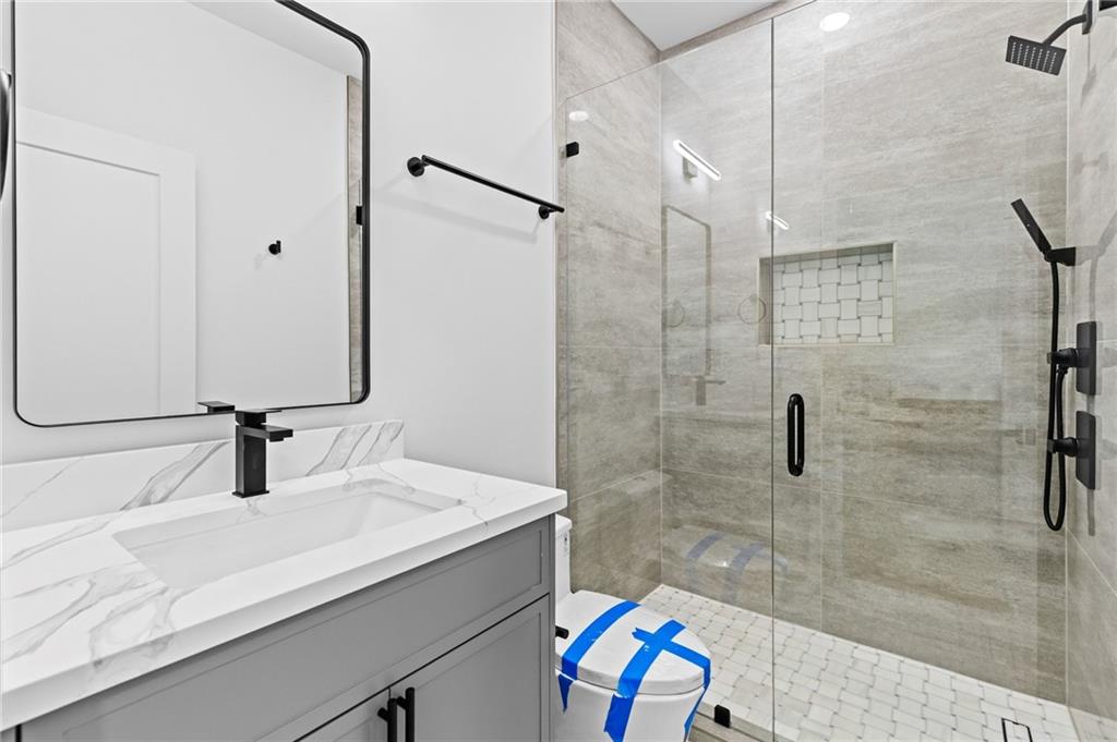 6996 Deaton Henry Road Hoschton, GA 30548 - Photo 41 of 65 a bathroom with a sink and a mirror