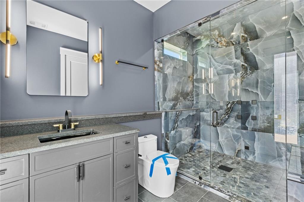 6996 Deaton Henry Road Hoschton, GA 30548 - Photo 47 of 65 a bathroom with a sink toilet and shower