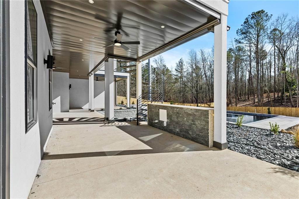 6996 Deaton Henry Road Hoschton, GA 30548 - Photo 55 of 65 a view of a patio with a table and chairs