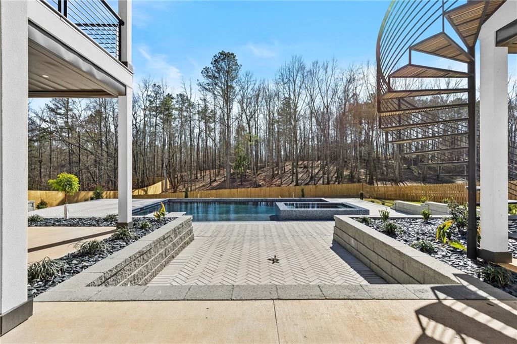 6996 Deaton Henry Road Hoschton, GA 30548 - Photo 58 of 65 a view of a swimming pool with a patio