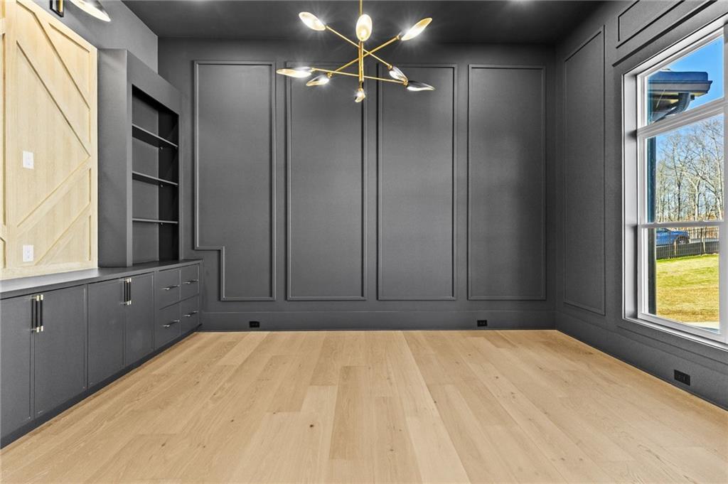 6996 Deaton Henry Road Hoschton, GA 30548 - Photo 6 of 65 a view of empty room with window and cabinet