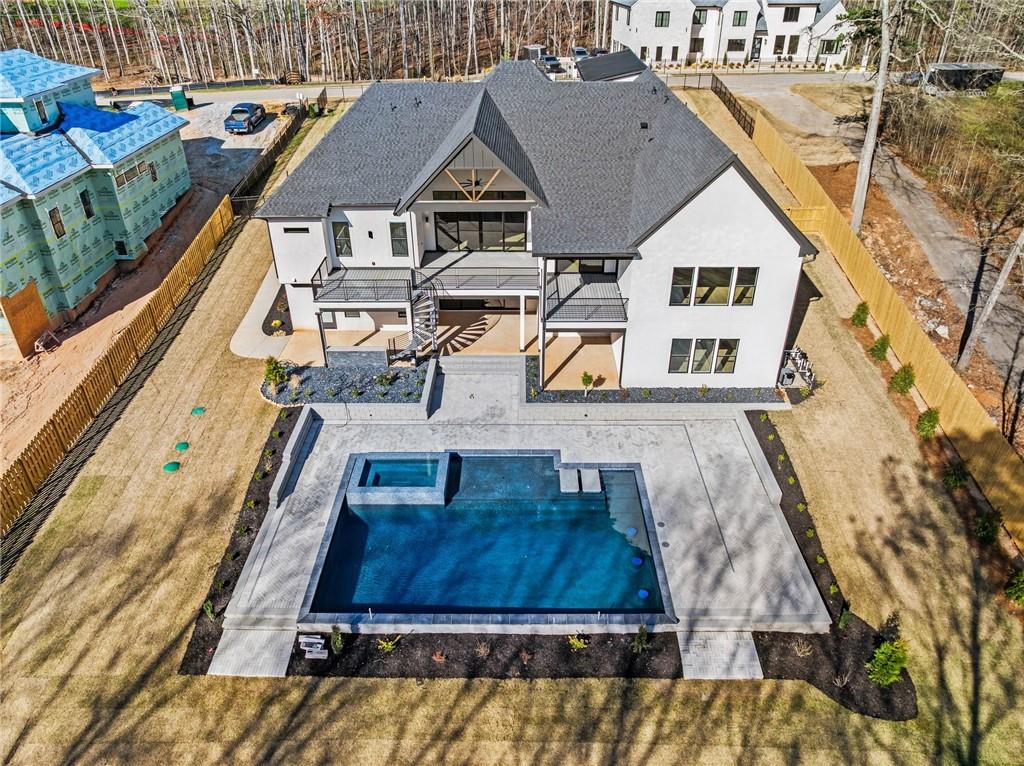 6996 Deaton Henry Road Hoschton, GA 30548 - Photo 61 of 65 an aerial view of a house with a swimming pool