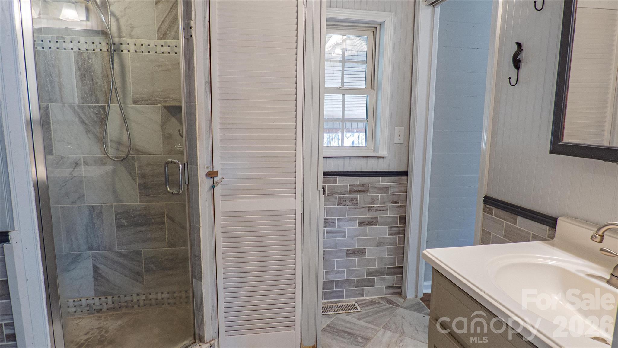 3920 St Peters Church Road Salisbury, NC 28146 - Photo 16 of 32 a bathroom with a sink a vanity and a shower