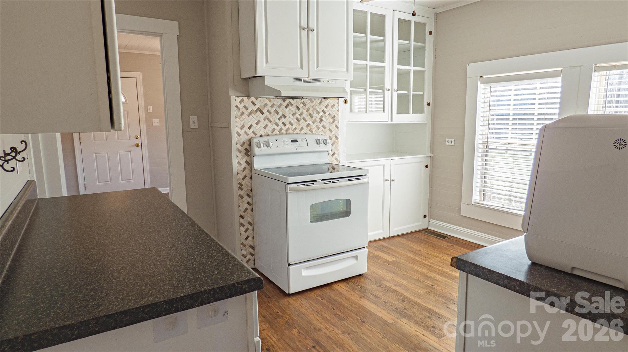 3920 St Peters Church Road Salisbury, NC 28146 - Photo 6 of 32 a kitchen with granite countertop white cabinets and white appliances