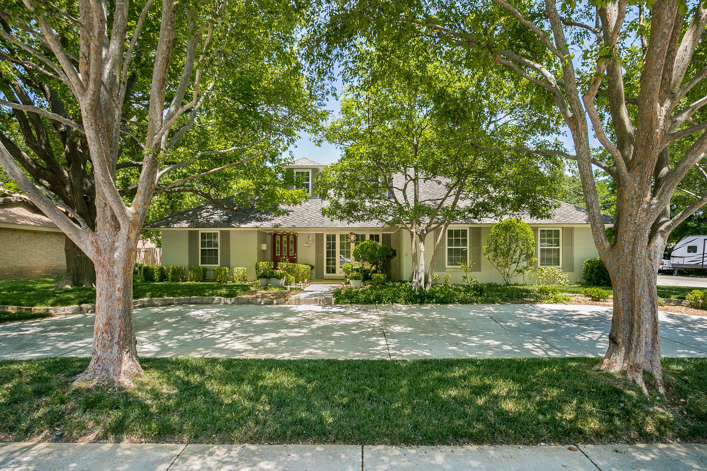 6700 Dreyfuss Road Amarillo, TX 79106 - Photo 1 of 37 a view of a yard in front of a house with large windows