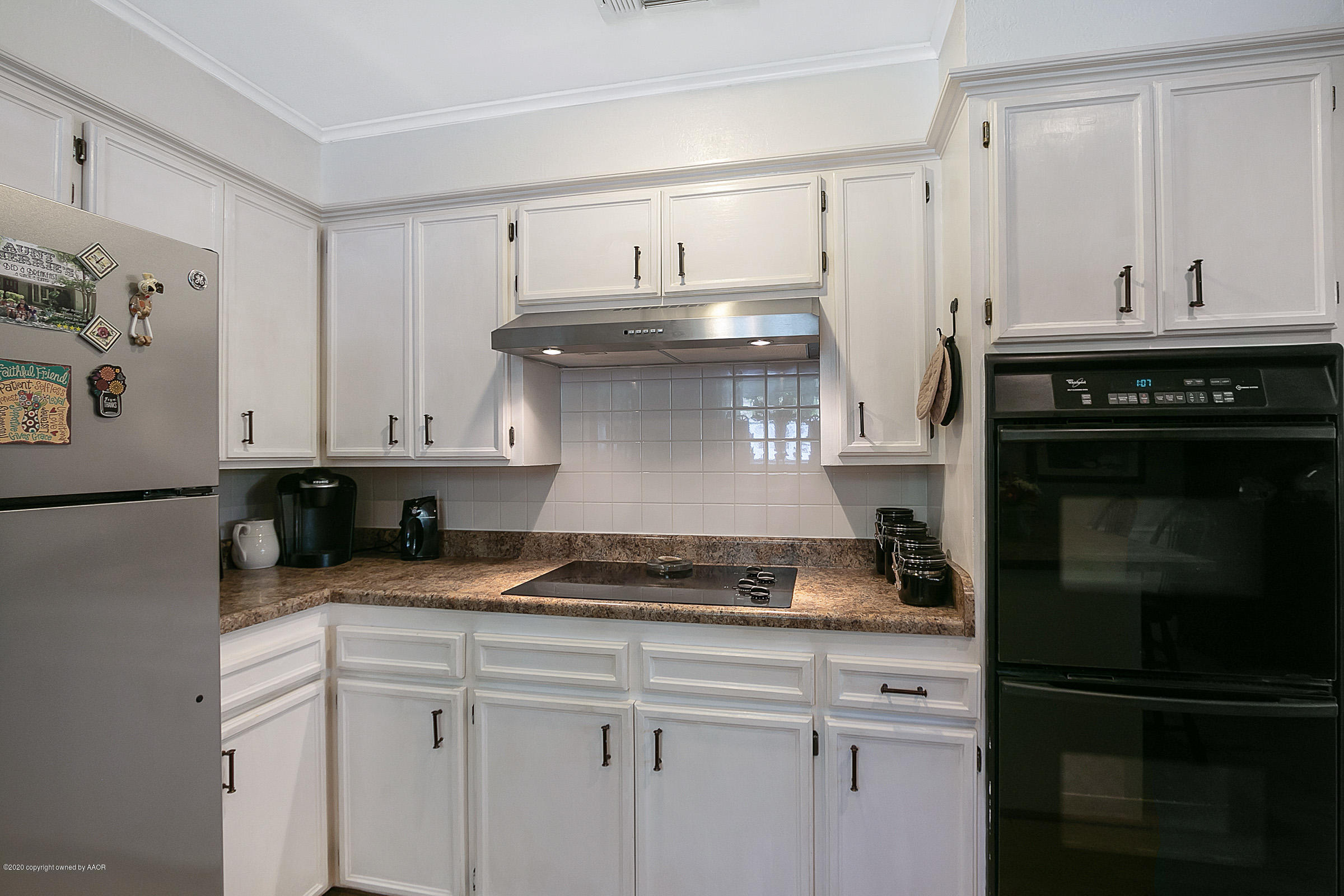 6700 Dreyfuss Road Amarillo, TX 79106 - Photo 15 of 37 a kitchen with stainless steel appliances granite countertop a stove and a refrigerator
