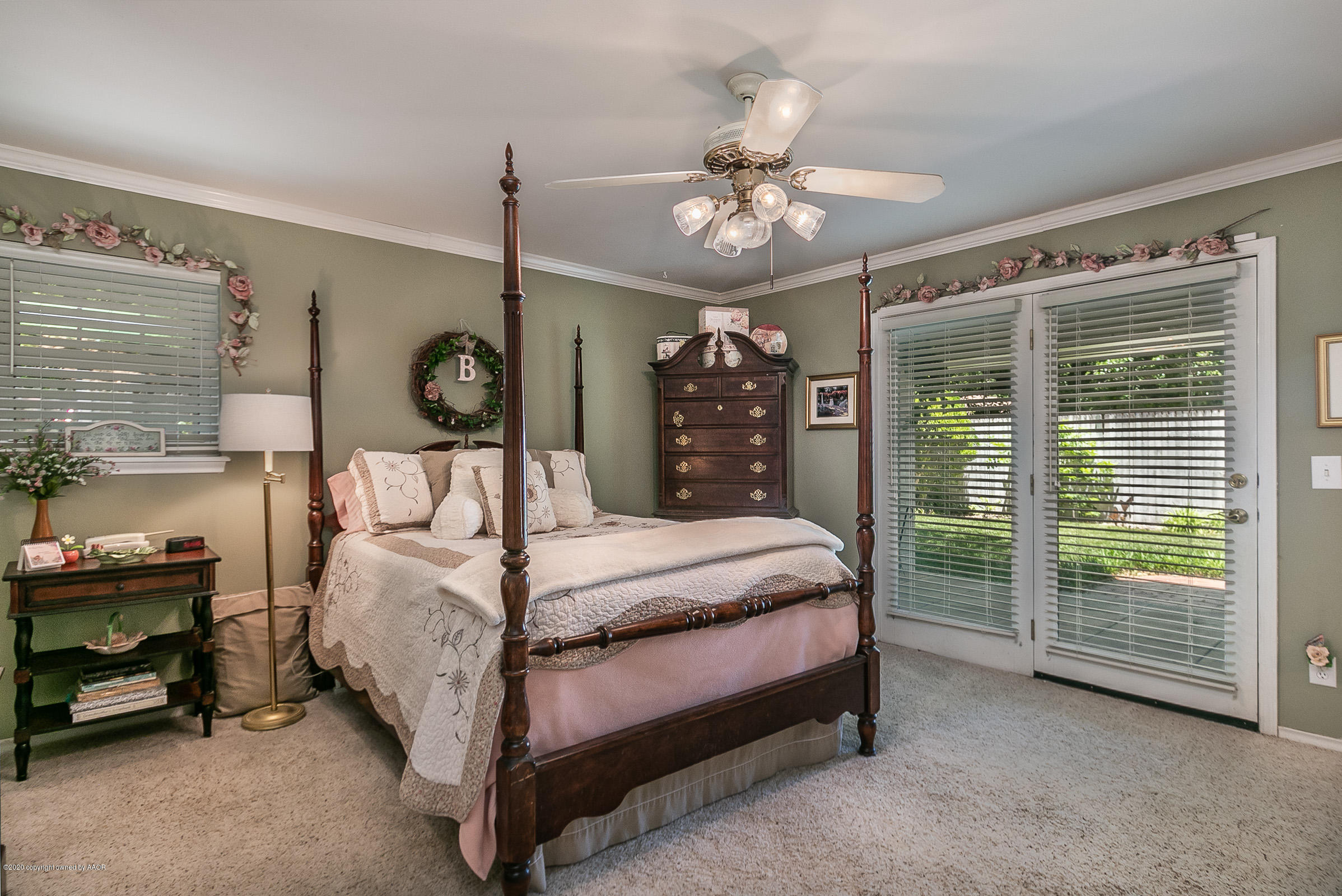 6700 Dreyfuss Road Amarillo, TX 79106 - Photo 19 of 37 a bedroom with a bed and a chandelier