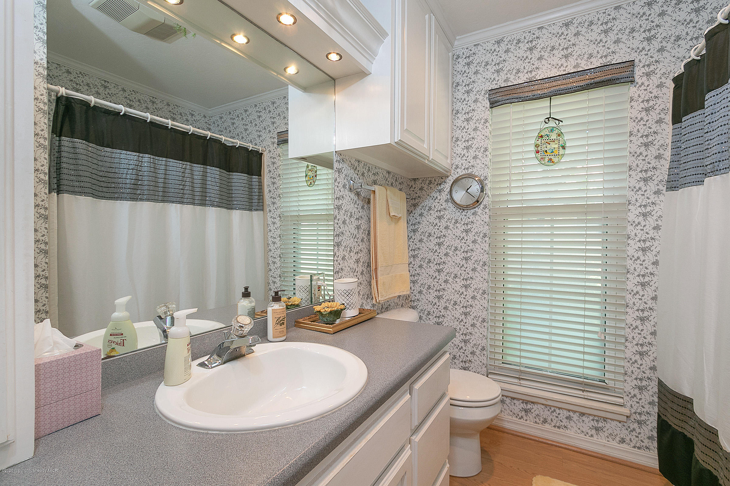 6700 Dreyfuss Road Amarillo, TX 79106 - Photo 27 of 37 a bathroom with a sink a toilet and shower curtain