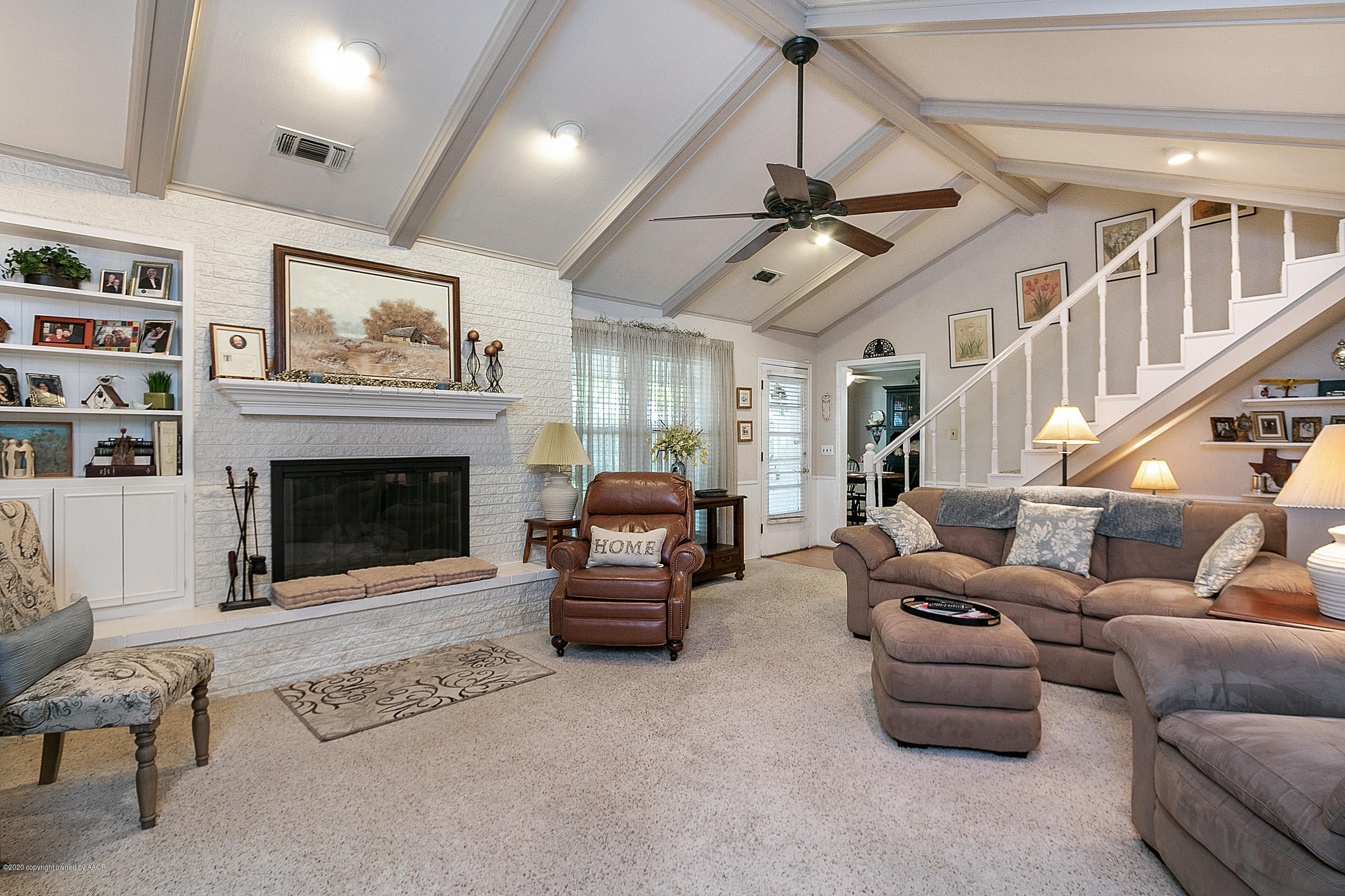 6700 Dreyfuss Road Amarillo, TX 79106 - Photo 9 of 37 a living room with furniture ceiling fan and a fireplace