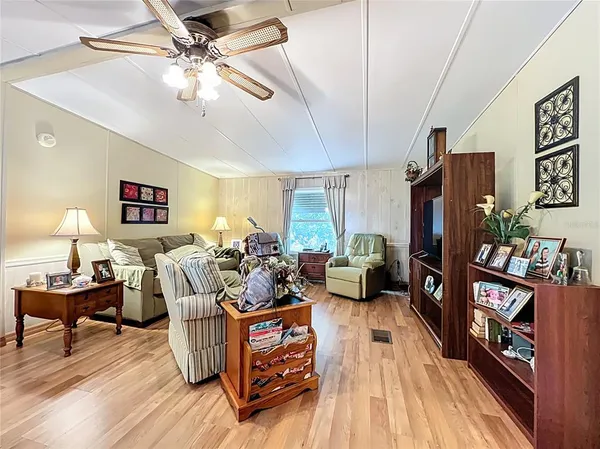 a living room with furniture and a wooden floor