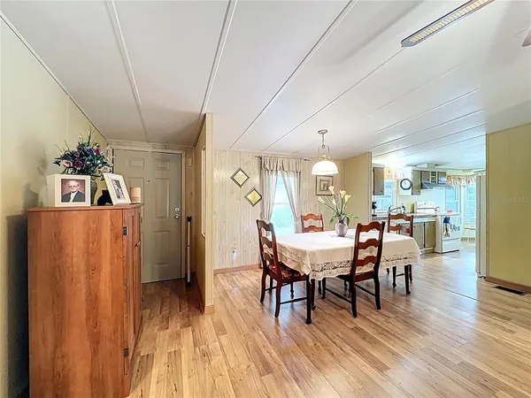 a bedroom with a large bed and a flat tv screen on dresser