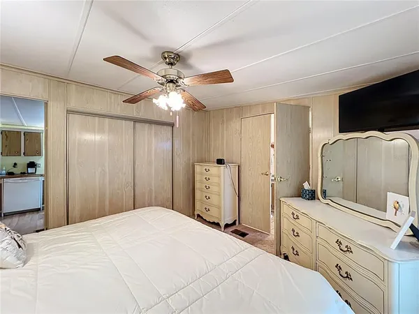 a bathroom with a granite countertop sink a toilet and a mirror