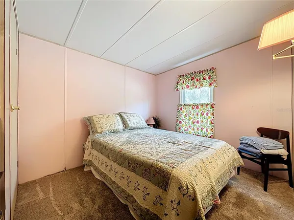 a dining room with furniture and a floor to ceiling window