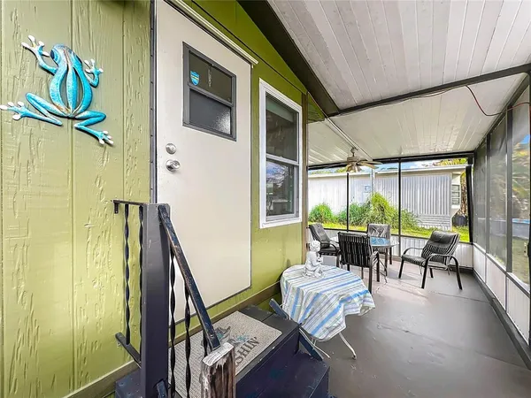 a backyard of a house with a table and chairs