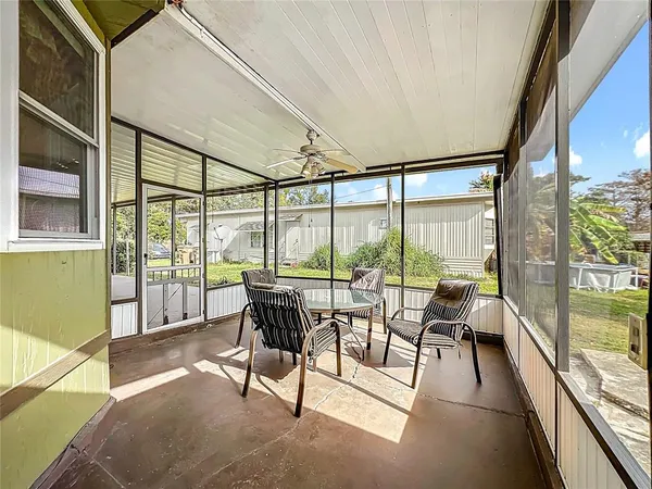 a living room with furniture and large windows