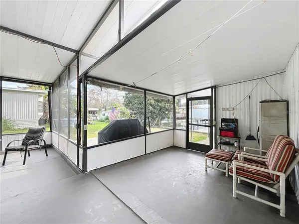 a view of a house with large windows and a outdoor space
