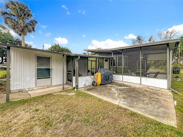 a view of a house with a wooden deck
