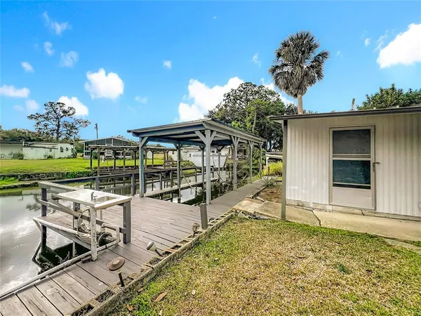 a view of a swimming pool with a patio and dining table