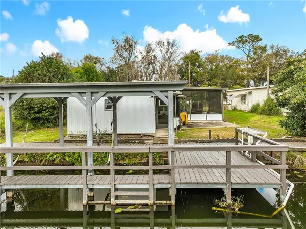 an aerial view of a house with a yard and potted plants