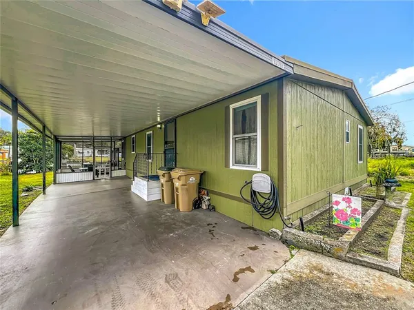 a backyard with a table and chairs and potted plants