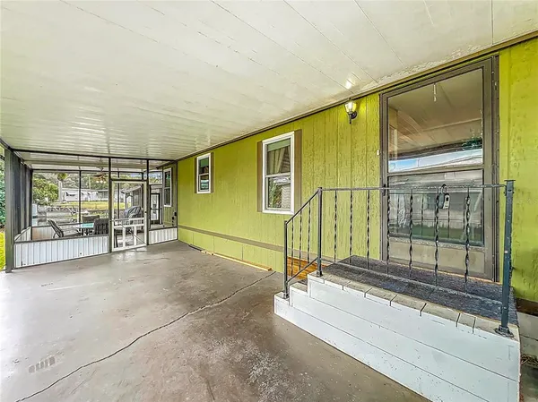 a kitchen with stainless steel appliances a refrigerator a stove a sink and white cabinets with wooden floor